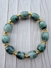 Dreamy Jade bracelet featuring smooth, deep green natural jade beads with polished gold-tone spacers.