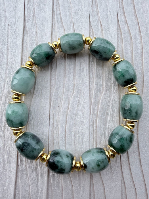 Dreamy Jade bracelet featuring smooth, deep green natural jade beads with polished gold-tone spacers.