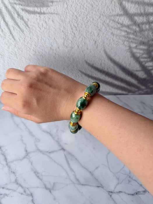 Dreamy Jade bracelet featuring natural green mottled jade beads and polished gold-tone spacers worn on a wrist