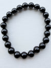 Dreamy Jade polished black obsidian round bead elastic bracelet with a minimalist unisex design