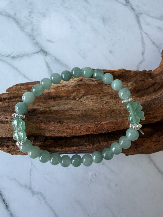 Dreamy Jade bracelet featuring smooth green jade beads and two hand-carved jade butterfly charms with silver spacers.