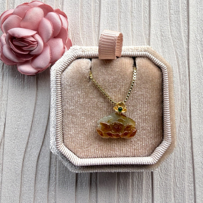 Dreamy Jade carved amber-toned jade pendant necklace with gold-tone floral setting and green gemstone on box chain