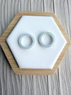 Dreamy Jade minimalist circular jadeite ring bands with smooth polished finish displayed on a white hexagonal stand