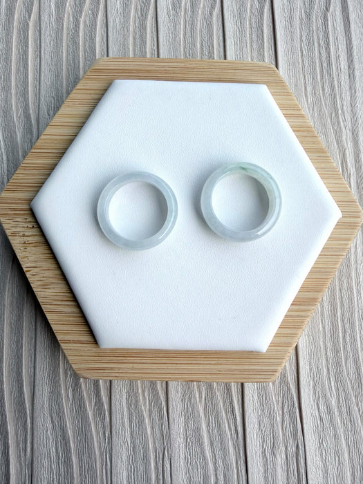 Dreamy Jade minimalist circular jadeite ring bands with smooth polished finish displayed on a white hexagonal stand