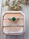 Dreamy Jade clover ring featuring four deep green jade stones set in polished silver on a velvet ring box