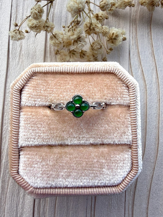Dreamy Jade clover ring featuring four deep green jade stones set in polished silver on a velvet ring box