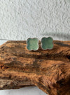 Dreamy Jade clover stud earrings featuring a soft green stone inlay with a delicate beaded metal border.