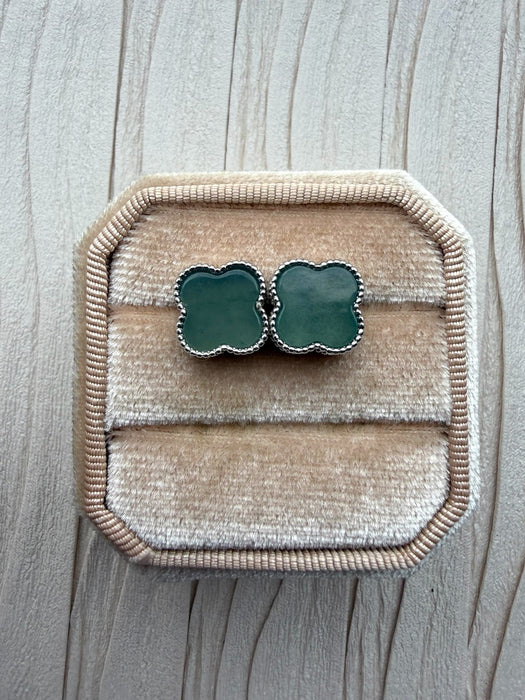 Dreamy Jade clover stud earrings featuring green stone inlay and a beaded metal edge in a velvet jewellery box.