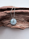 Dreamy Jade donut pendant necklace featuring a translucent green polished jade stone on a silver-tone chain.