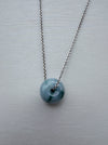 Dreamy Jade donut pendant necklace featuring a polished translucent green jade stone on a silver-tone chain