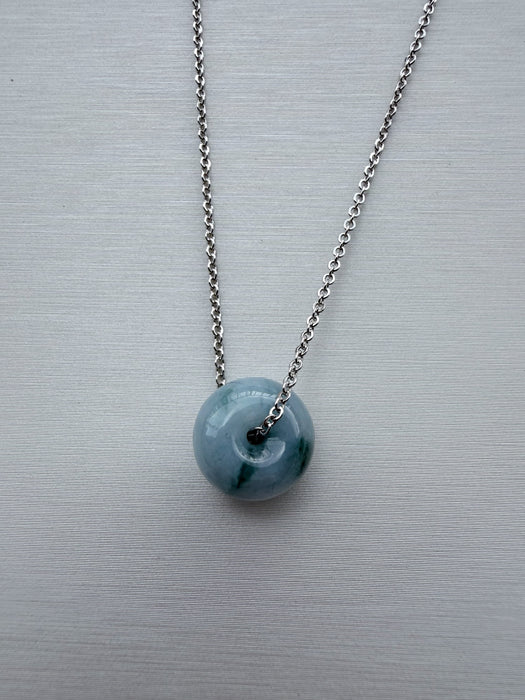 Dreamy Jade donut pendant necklace featuring a polished translucent green jade stone on a silver-tone chain