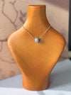 Dreamy Jade donut pendant necklace featuring a polished translucent green jade bead on a delicate silver-tone chain.