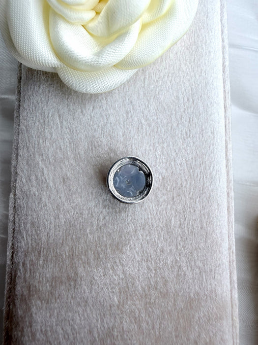 Dreamy Jade floral clover charm featuring icy-blue jade petals and a central accent stone in sterling silver setting.