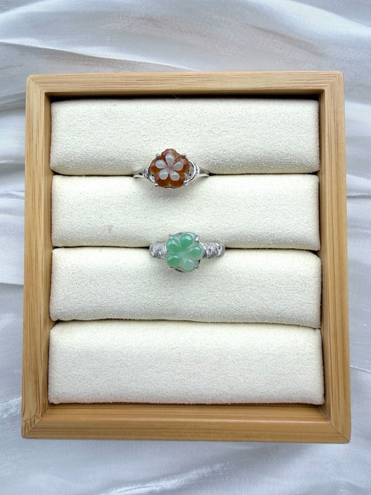 Dreamy Jade floral rings featuring carved green and amber jade flower gemstones on polished silver-tone bands.