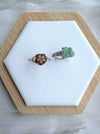 Dreamy Jade floral rings featuring carved green and amber jade petals on polished silver-tone bands