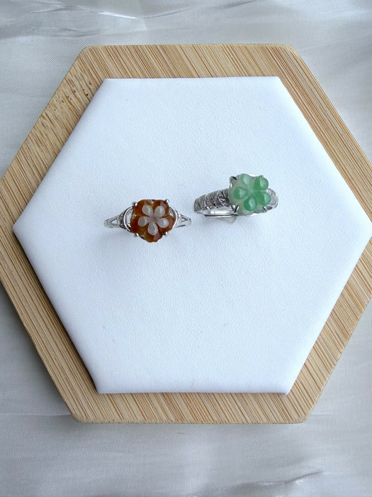 Dreamy Jade floral rings featuring carved green and amber jade petals on polished silver-tone bands