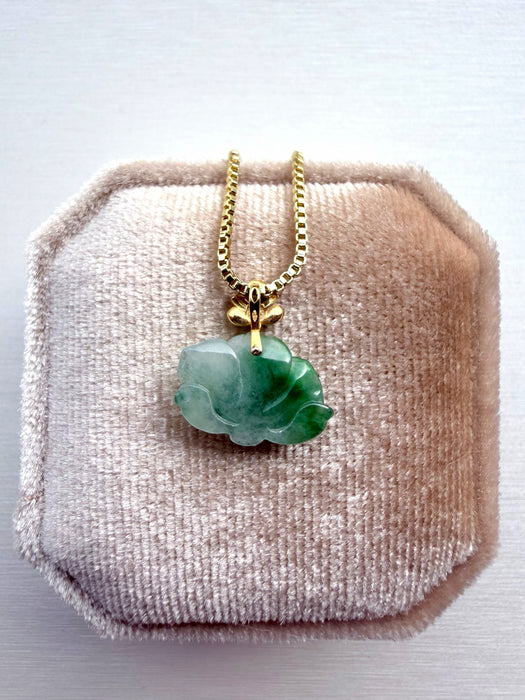 Dreamy Jade floral pendant necklace featuring a carved green jade flower on a gold-tone box chain in a velvet box.