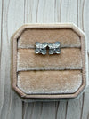 Dreamy Jade floral stud earrings featuring cabochon jade stones and pavé crystals in a silver-tone clover design.