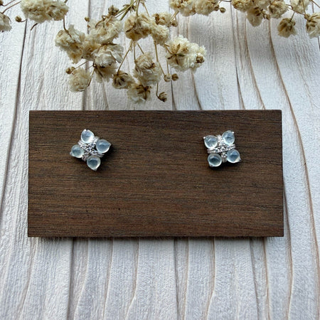 Dreamy Jade floral stud earrings featuring cabochon-cut jade stones in a clover motif with pavé crystals on silver-tone.