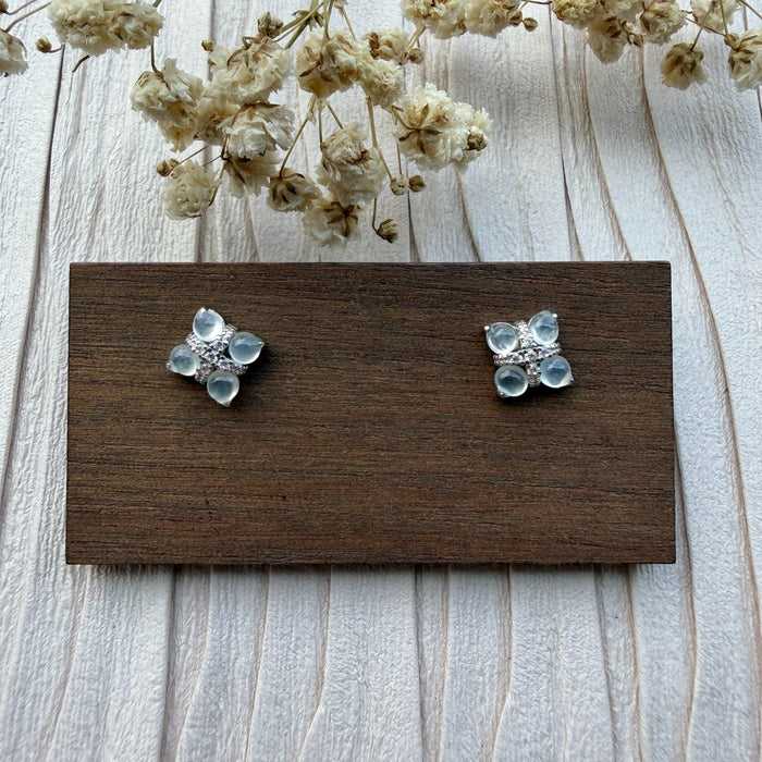 Dreamy Jade floral stud earrings featuring cabochon-cut jade stones in a clover motif with pavé crystals on silver-tone.