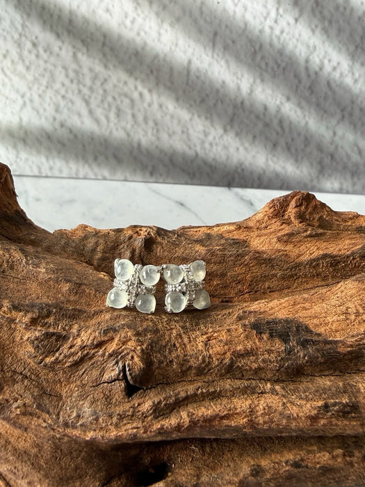 Dreamy Jade floral stud earrings featuring cabochon jade stones and pavé crystals set in polished silver-tone metal.