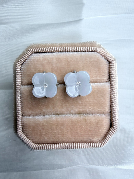 Dreamy Jade floral stud earrings featuring carved light jade petals and a central stone in a velvet jewellery box.
