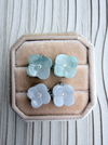 Dreamy Jade floral stud earrings with carved light green and white jade petals and central crystal accents in a box.