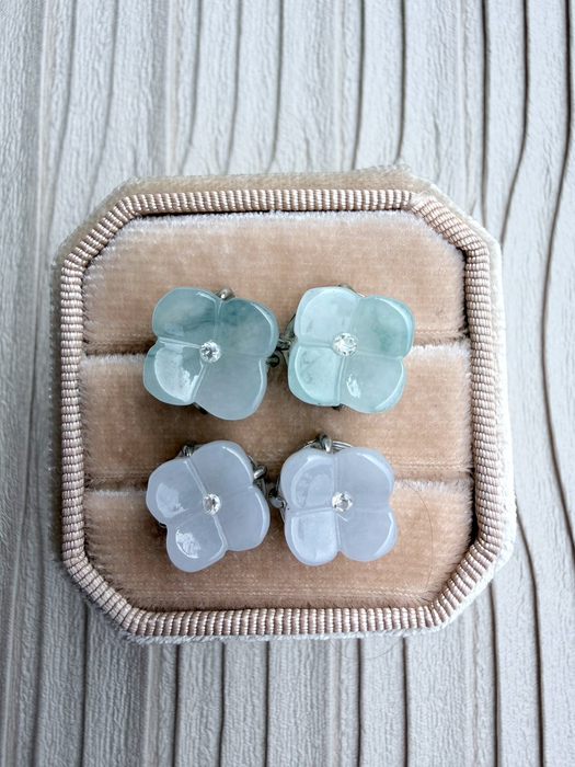 Dreamy Jade floral stud earrings with carved light green and white jade petals and central crystal accents in a box.