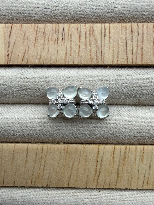 Dreamy Jade floral stud earrings featuring cabochon-cut jade stones and pavé crystals in a silver-tone setting.