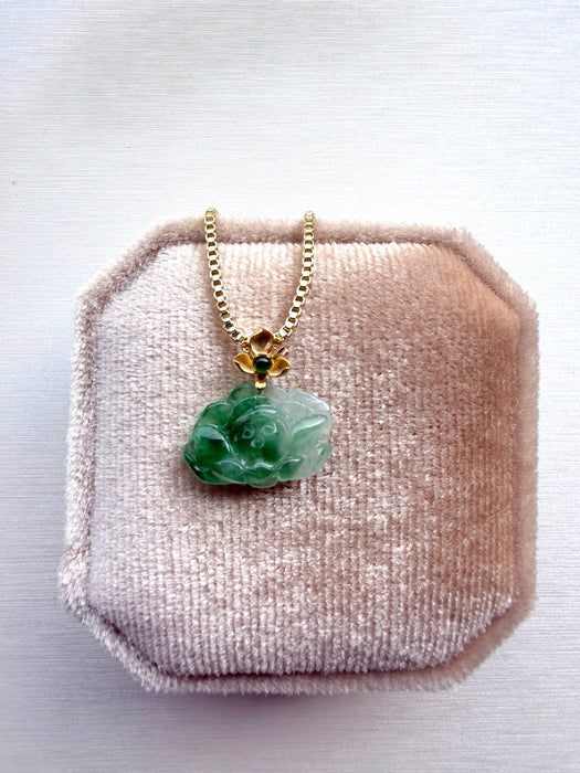 Dreamy Jade floral pendant necklace featuring carved green jade on a gold-tone box chain in a velvet jewellery box.