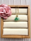Dreamy Jade floral pendant necklace featuring carved green jade on a gold-tone box chain in a wooden display box.