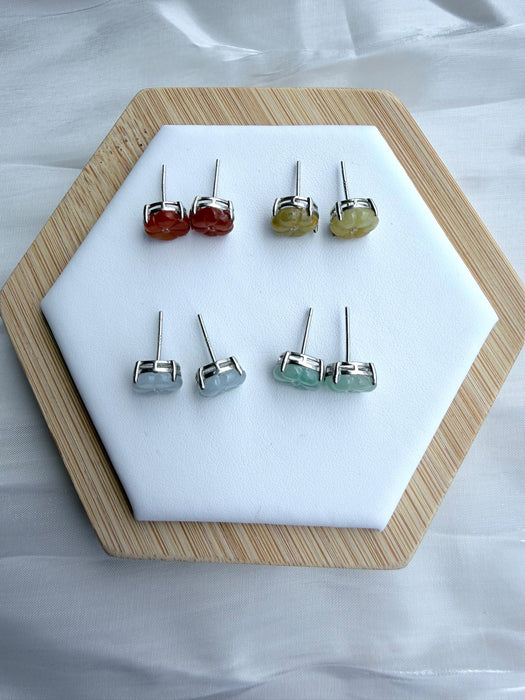 Dreamy Jade floral stud earrings in red, yellow, icy white, and mint green jade set in polished metal on a display.