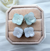 Dreamy Jade floral stud earrings with carved pale green and lavender jade petals and a central crystal accent.