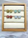 Dreamy Jade floral stud earrings in yellow, mint green, sunset red, and icy white jade set in polished metal.