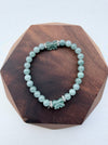 Dreamy Jade bracelet featuring smooth green jade beads and two hand-carved jade butterfly charms with silver spacers.