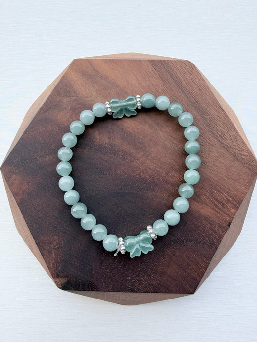 Dreamy Jade bracelet featuring smooth green jade beads and two hand-carved jade butterfly charms with silver spacers.