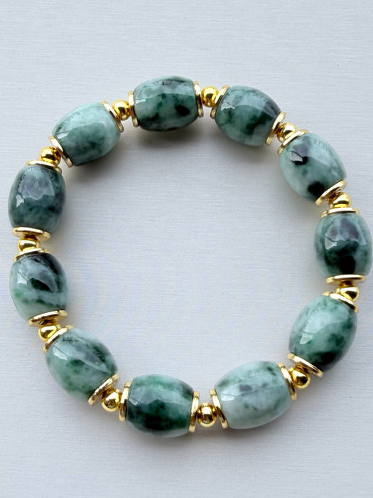 Dreamy Jade bracelet featuring smooth green mottled jade beads and polished gold-tone spacers on a white background.