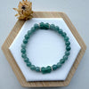 Dreamy Jade bracelet featuring polished green jade beads and two hand-carved jade butterfly charms with silver spacers.