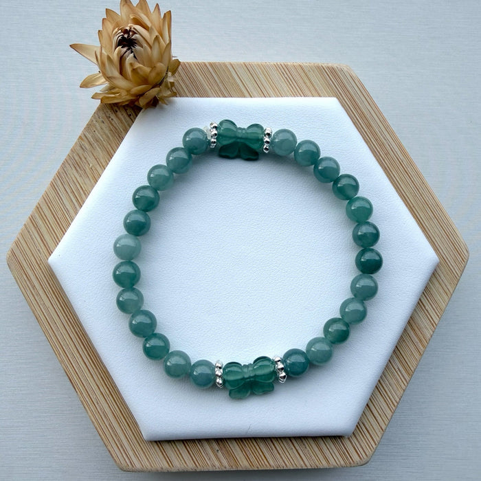 Dreamy Jade bracelet featuring polished green jade beads and two hand-carved jade butterfly charms with silver spacers.