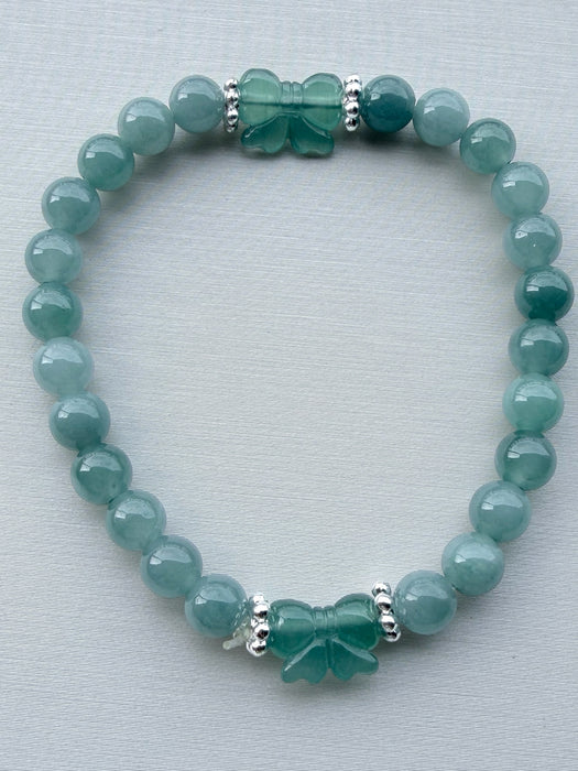 Dreamy Jade bracelet featuring polished green jade beads and two hand-carved jade butterfly charms with silver spacers.