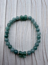 Dreamy Jade bracelet featuring polished green jade beads, silver-tone spacers, and two hand-carved jade butterflies.