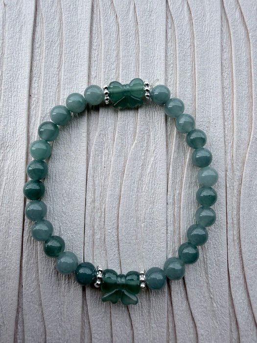 Dreamy Jade bracelet featuring polished green jade beads, silver-tone spacers, and two hand-carved jade butterflies.