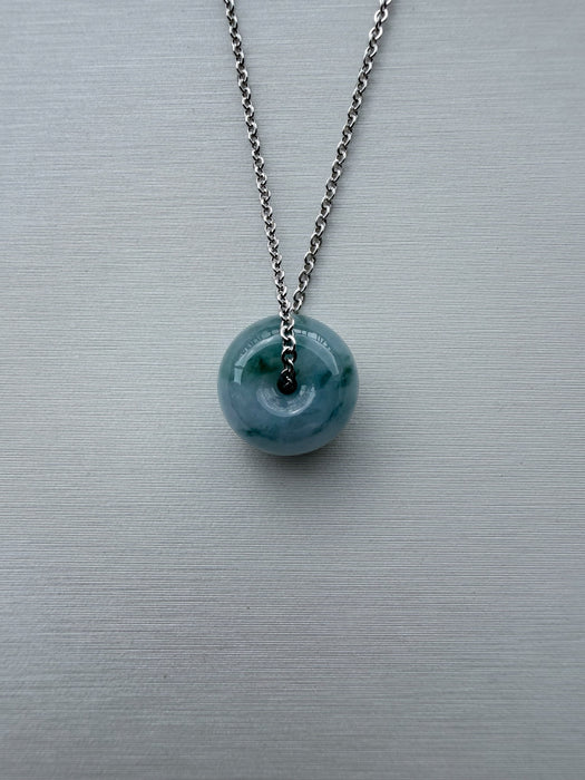 Dreamy Jade donut pendant necklace featuring a translucent green marbled stone on a silver-tone chain