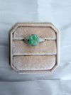Dreamy Jade floral ring featuring a carved green jade flower on a textured silver-tone band in a velvet ring box.