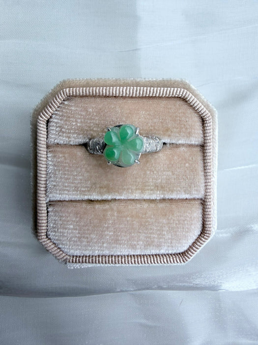 Dreamy Jade floral ring featuring a carved green jade flower on a textured silver-tone band in a velvet ring box.