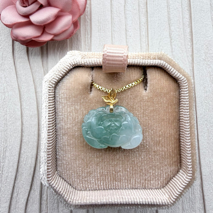 Dreamy Jade peony pendant necklace in natural green jade with a gold-tone leaf bail on a box chain in a velvet box.