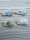 Four Dreamy Jade hand-carved rabbit charms with gold-tone clasps, featuring smooth, lustrous natural jade stone.