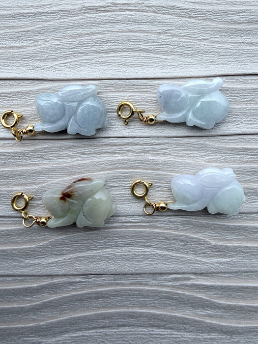 Four Dreamy Jade hand-carved rabbit charms with gold-tone clasps, featuring smooth, lustrous natural jade stone.