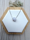 Dreamy Jade lavender jade pendant necklace with hand-carved floral motif on a minimalist silver-tone chain.
