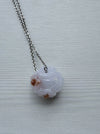 Dreamy Jade lavender jade pendant necklace with hand-carved floral motif and silver-tone chain on a grey background